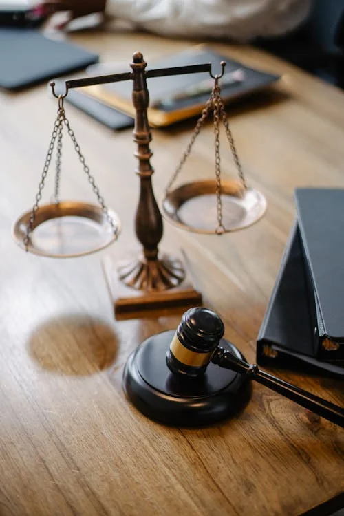Gavel and scales with documents on a table