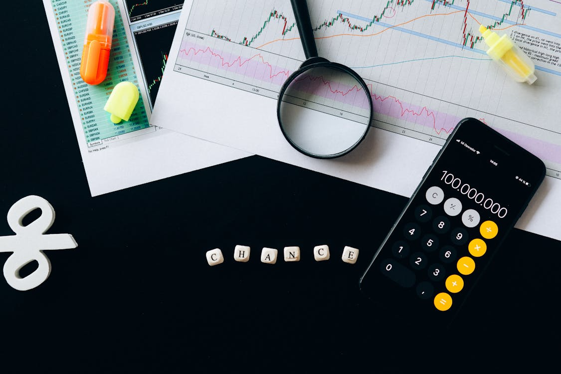 Reports and calculator on black table.